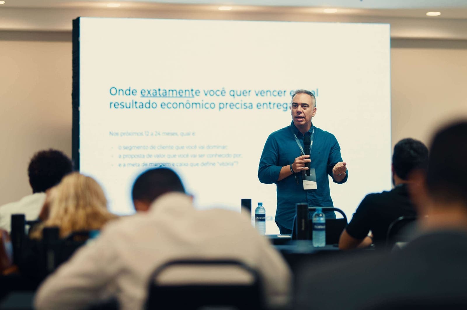 Professor conduzindo a aula diante do telão